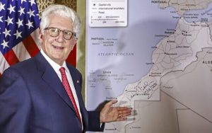 David Fischer, the US ambassador to Morocco, stands before a new US State Department map of Morocco recognizing the internationally-disputed territory of the Western Sahara (bearing a signature by Fischer) as a part of the North African kingdom, in the Moroccan capital Rabat on December 12, 2020. (AFP)
